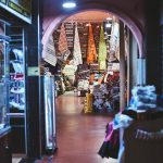 Vibrant Moroccan market scene displaying stacks of colorful textiles and rugs.